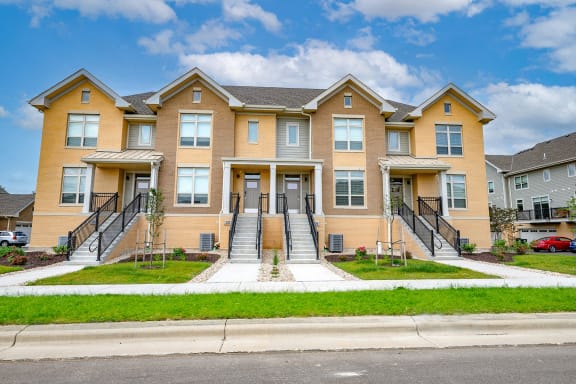 a row of houses in Middleton, WI with stairs and grass in front of them