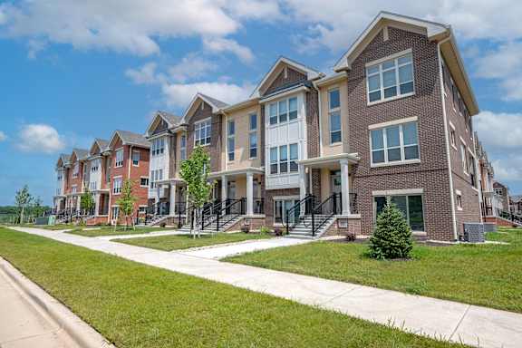 a row of brick apartment buildings on a sunny day