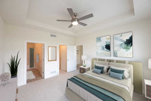 a Middleton, WI row home bedroom with a large bed and a ceiling fan