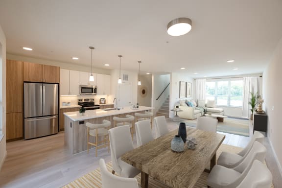 a kitchen and dining room in a Middleton, WI row home with a table and chairs