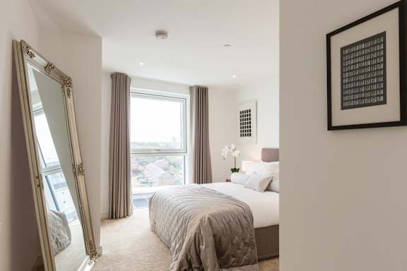 a bedroom with a large bed and a large window
