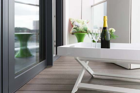 a white table with a bottle of wine on it
