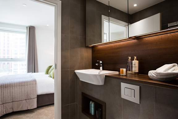 a bathroom with a sink and a mirror in a hotel room