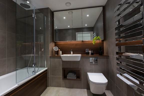 a bathroom with a toilet and a sink and a shower