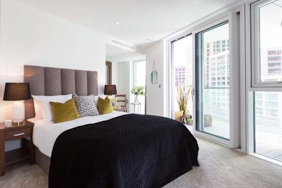 a bedroom with a large bed and a large window
