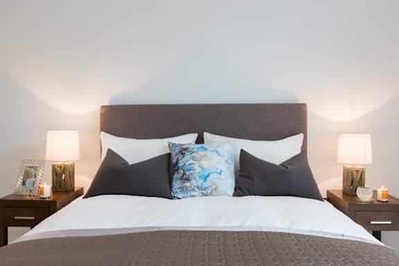 a bedroom with a bed with pillows and a headboard