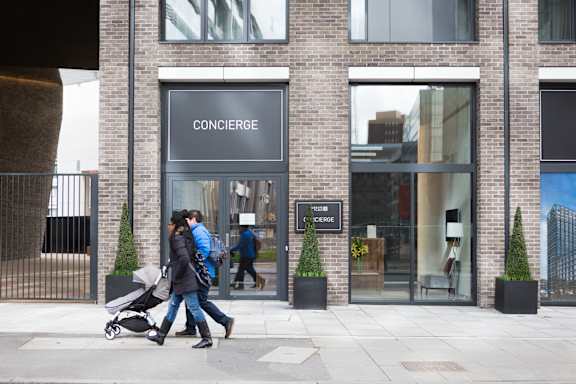 people walking past a converse store on a city street