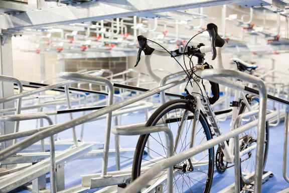 a bike parked on a rail in a bike rack