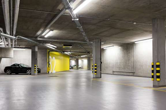 an empty parking garage with a car in it