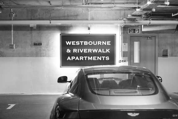 a car parked in a parking garage with a sign
