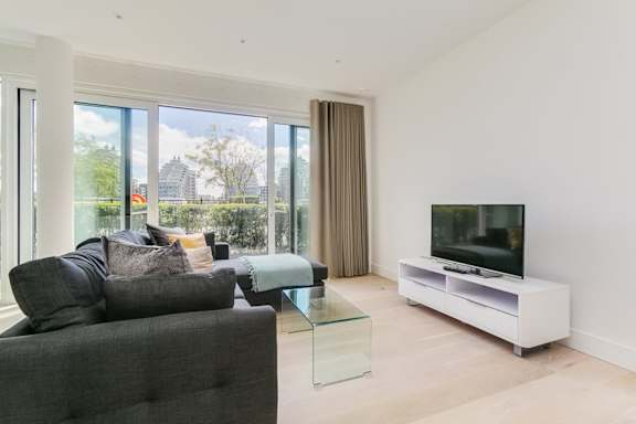 a living room with a couch and a glass table