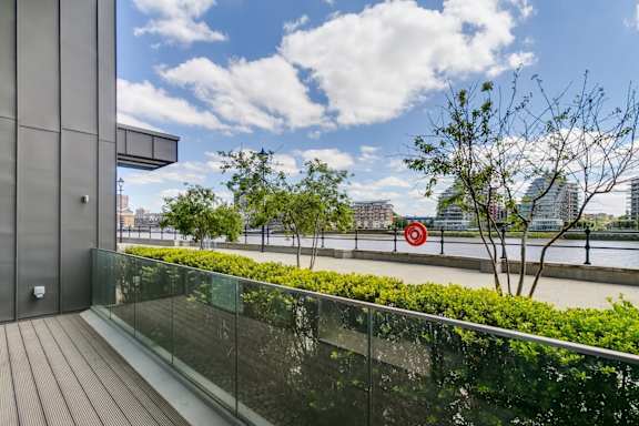 a balcony with a view of a river and buildings