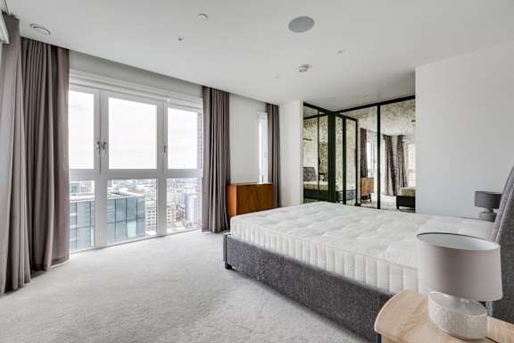 a bedroom with a large bed and a large window