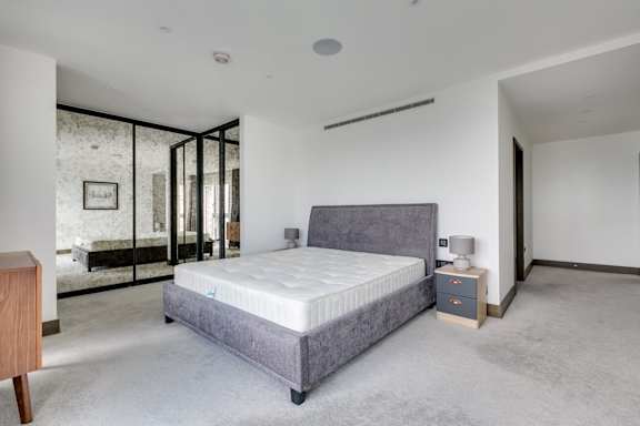 the master bedroom has a large ensuite bathroom with a large bed