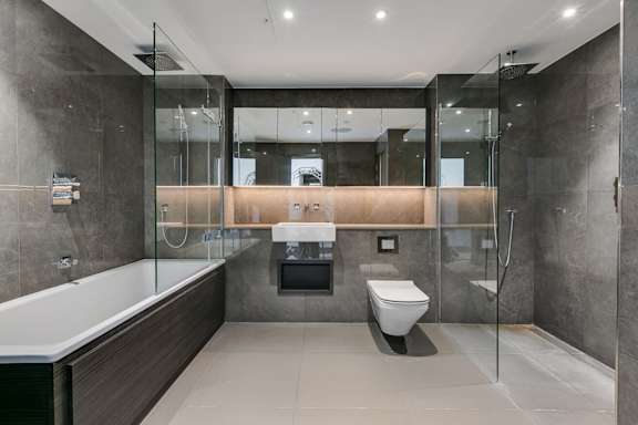 a bathroom with a toilet and a bath tub