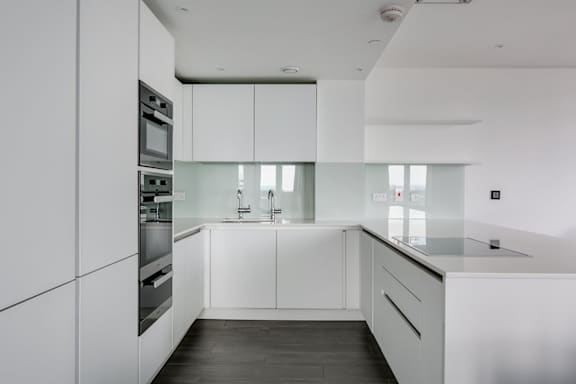 a kitchen with white cabinets and a counter top