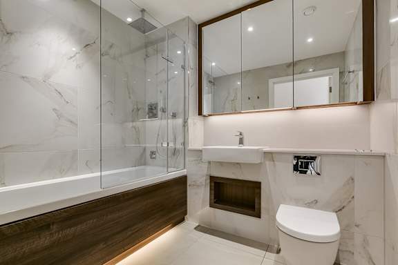 a bathroom with a toilet and a shower and a sink