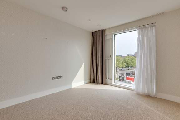 an empty living room with a large window