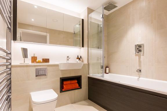 a bathroom with a toilet and a tub and a shower