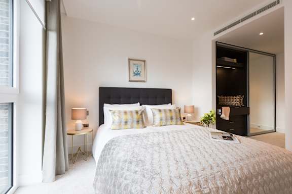 a bedroom with a large bed and a large window