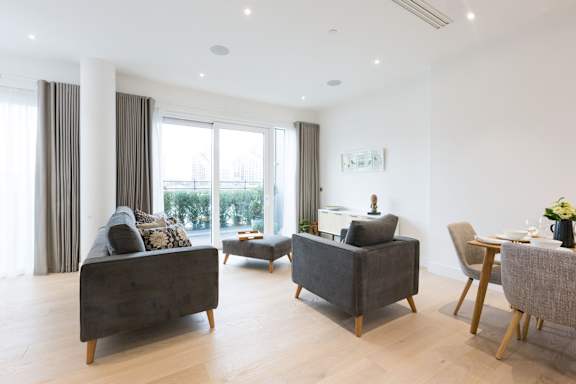 a living room with couches and chairs and a dining table