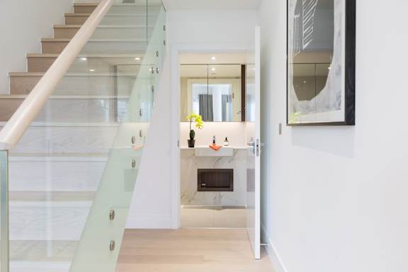 A modern interior with a staircase and a fireplace.