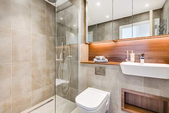 a bathroom with a toilet and a shower