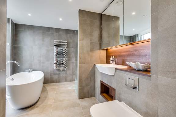 a bathroom with a tub and a sink and a shower