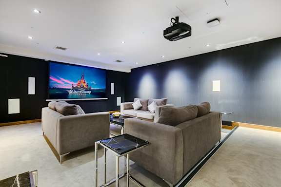 a living room with couches and a tv on the wall