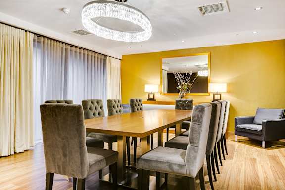 a dining room with a long wooden table and chairs