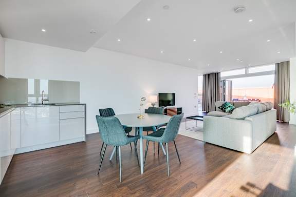 a living area with a dining table and a couch