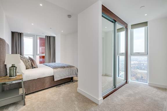 a bedroom with a large bed and a large window