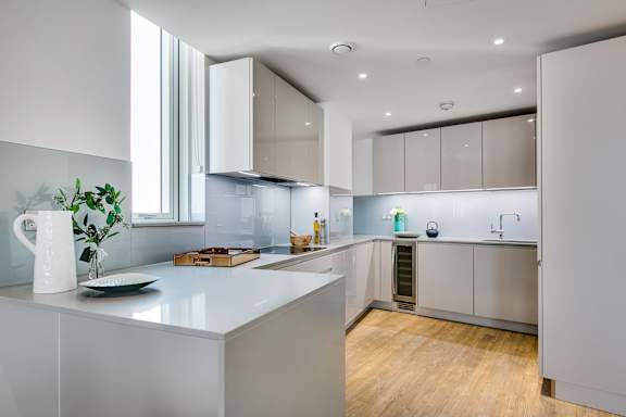 a kitchen with white cabinets and a white counter top