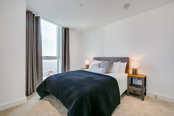 a bedroom with a large bed and a window