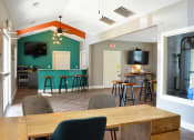 Thumbnail 13 of 22 - Clubhouse and leasing office with kitchen and counter top seating