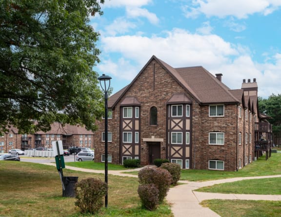 a large brick building with a sidewalk in front of it