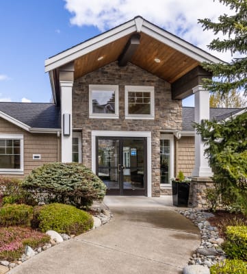 a home with a walkway leading to the front door