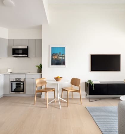 A modern kitchen with a dining table and chairs.