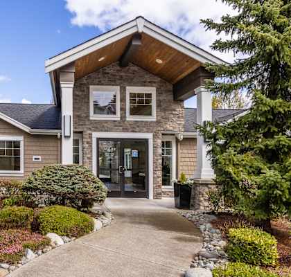 a home with a walkway leading to the front door
