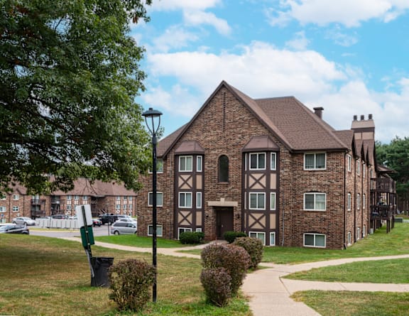 a large brick building with a sidewalk in front of it