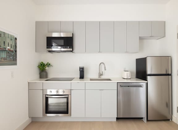 A modern kitchen with a table and chairs.