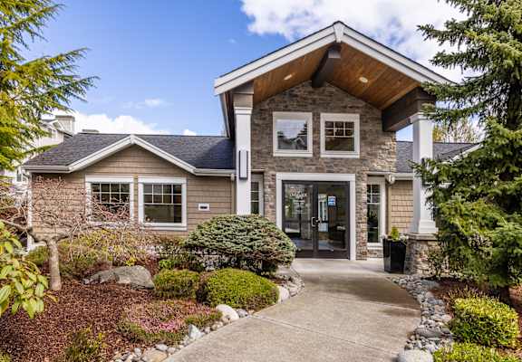 a home with a walkway leading to the front door