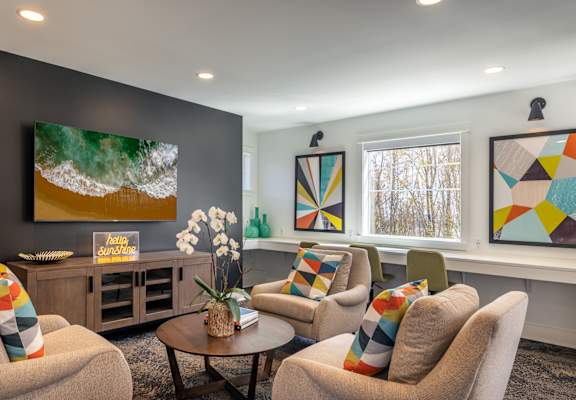 a living room filled with furniture and a large window