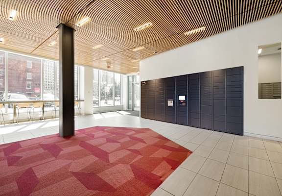 A room with a red carpet and a wooden ceiling.