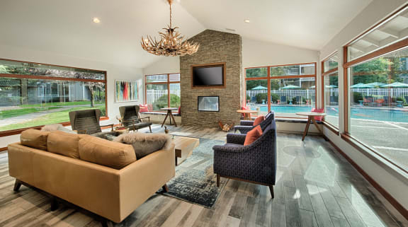 a living room with a fireplace and large windows
