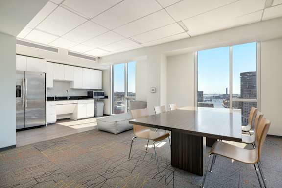 A conference room with a long table and chairs.