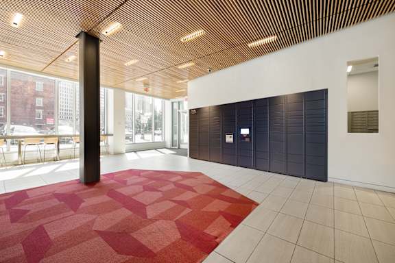 A room with a red carpet and a wooden ceiling.