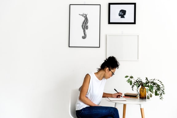 Woman sitting at a desk writing