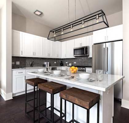 a kitchen with a center island and three stools