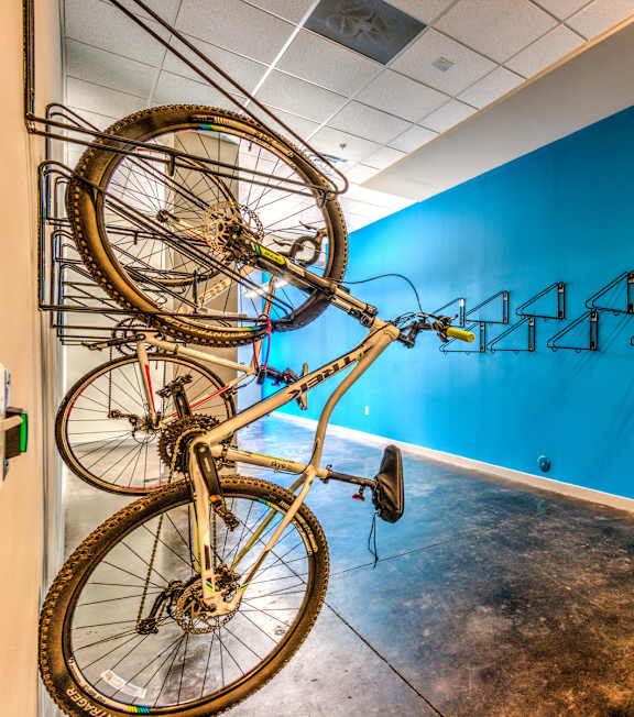 A room with a blue wall and a bicycle hanging on the wall. A room with a blue wall and a bicycle hanging on the wall at Highland Row Apartments, Memphis, 38111
